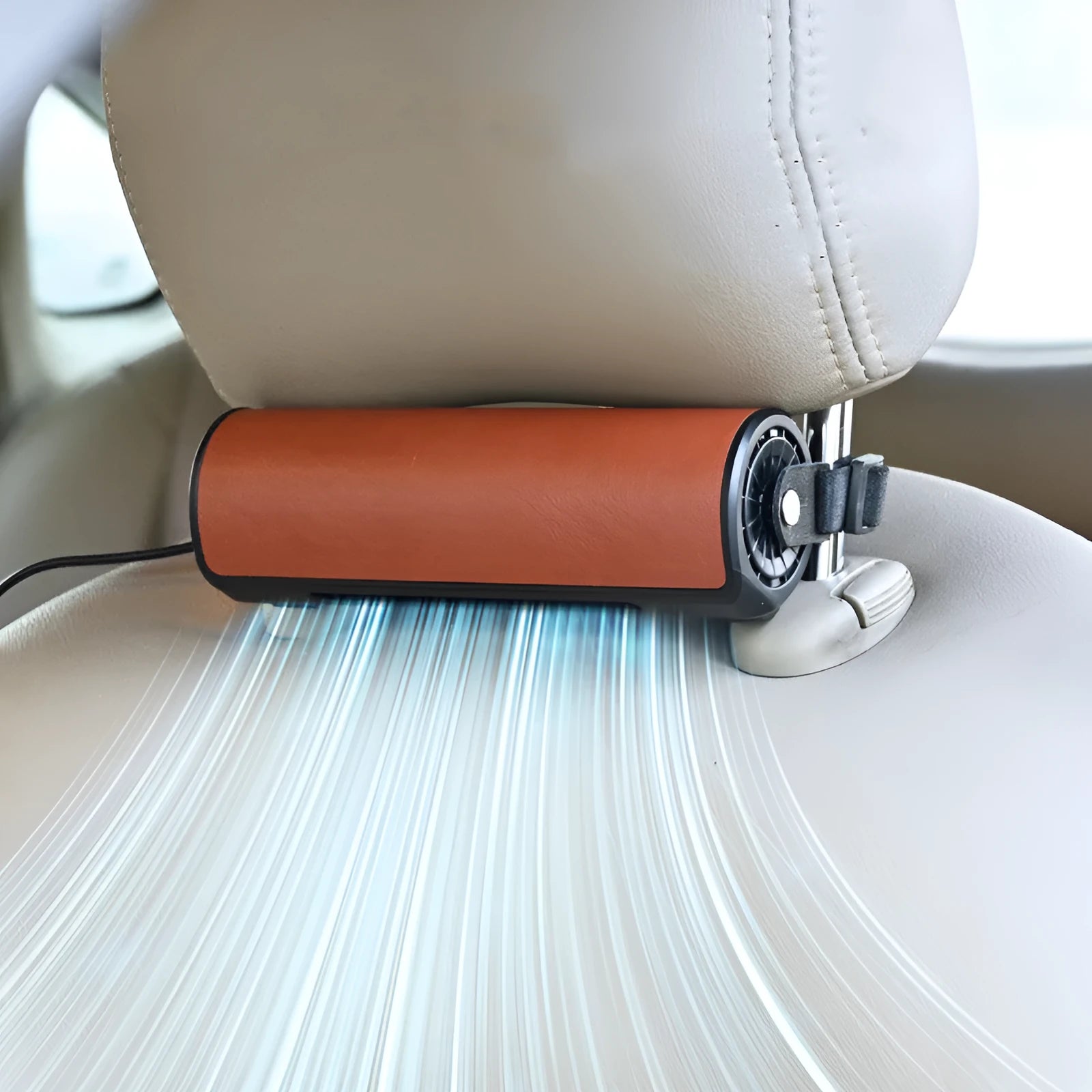 Compact black USB car fan for rear seats with a long cable on a car seat.