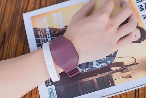Square digital electronic watch with touch screen on a coloured PU strap.
