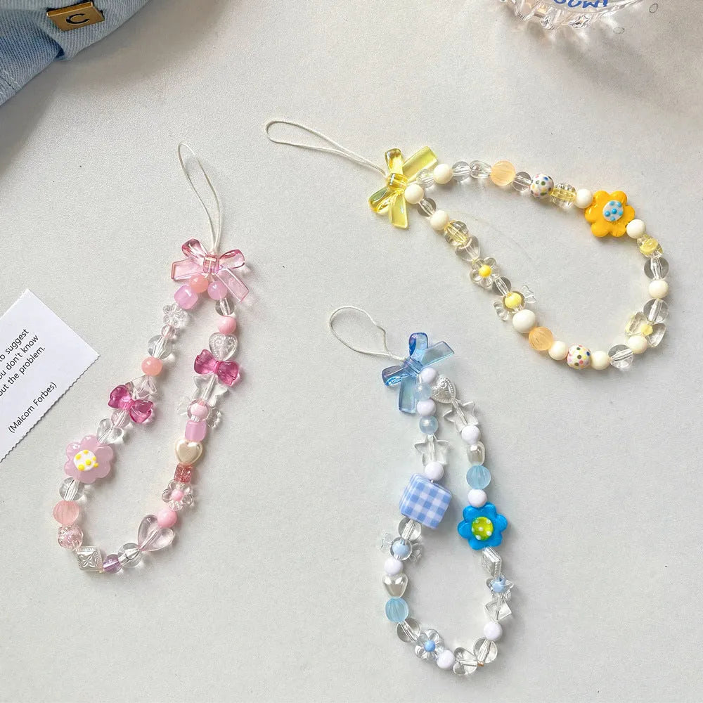 Beaded flower mobile phone lanyard with plastic resin decorative flowers and hand rope strap in blue colour