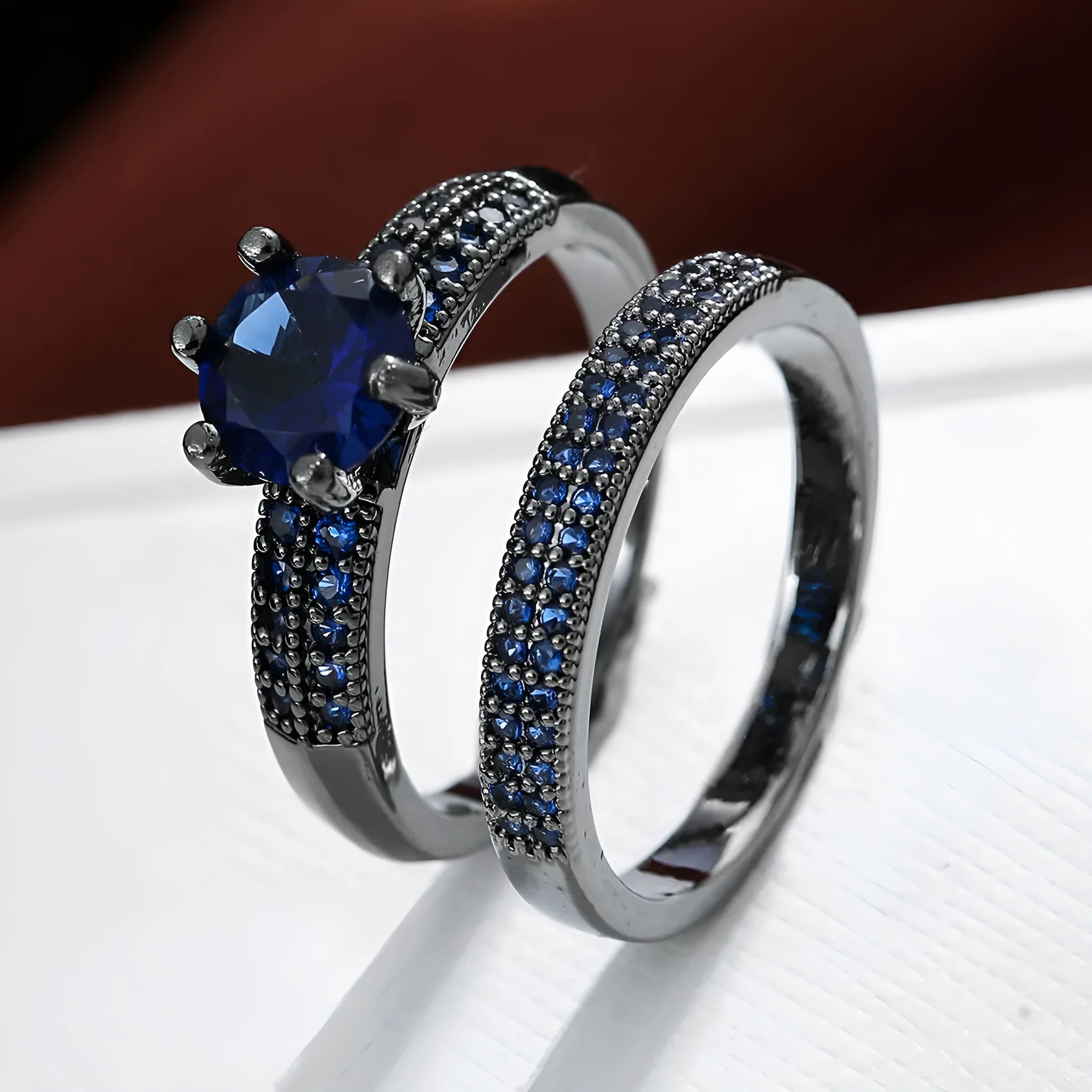 Two copper zircon hollow geometric rings with electroplated colour finish on white background