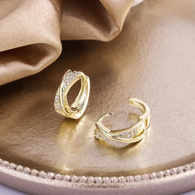 Geometric copper earrings with 14K yellow finish and zircon treatment.