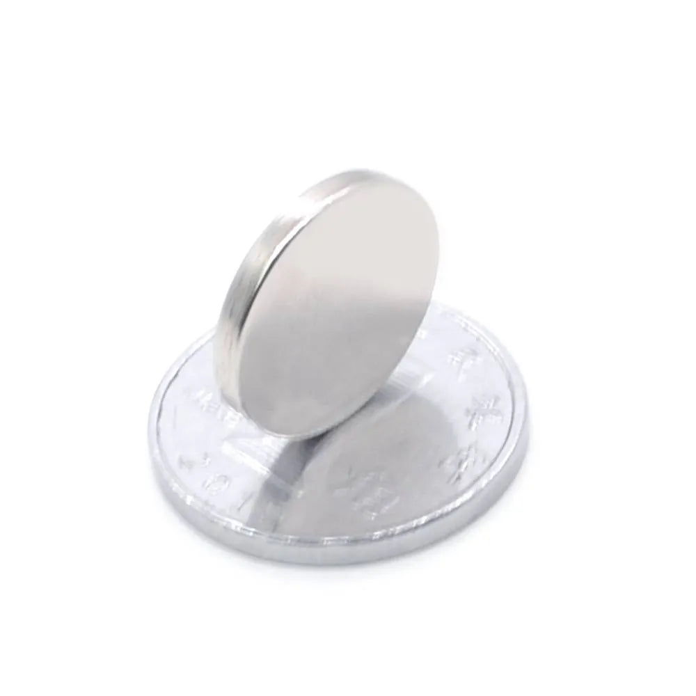 Silver NdFeB disc magnet 14mm diameter 2mm thickness on white background