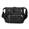 Grey nylon shoulder messenger bag with a single strap and square vertical shape on a neutral background.