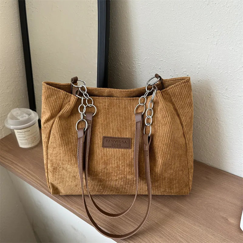 Corduroy one-shoulder large capacity tote handbag for women in black, brown, and white with outer pocket