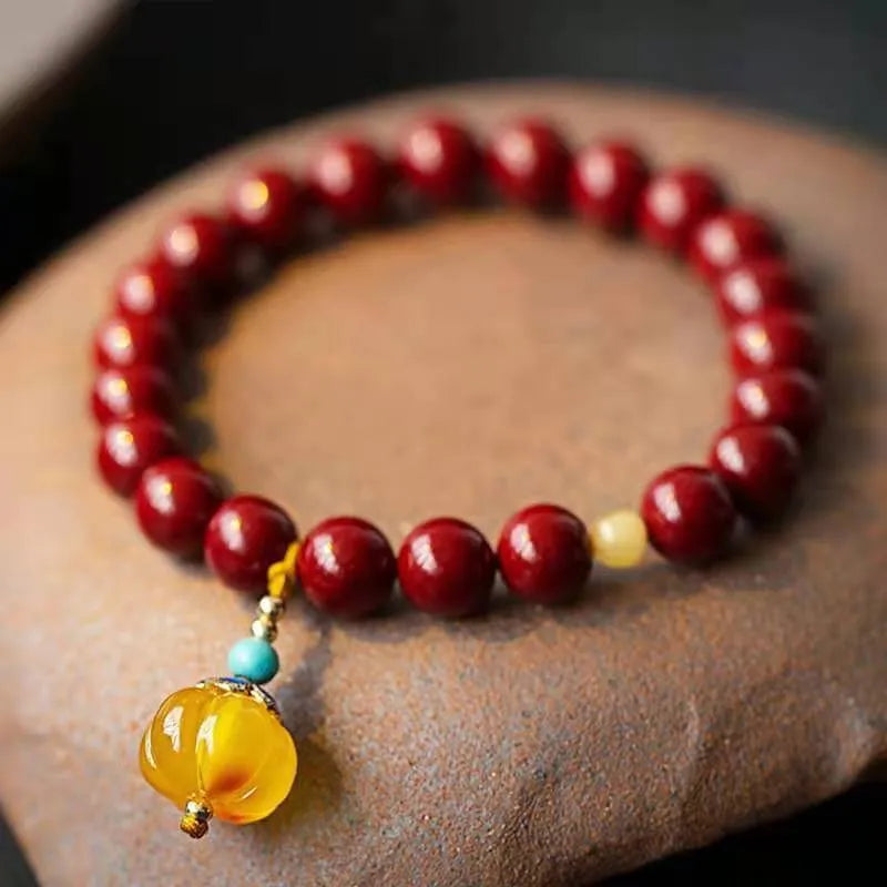 Gold cinnabar wave bracelet with copper bead on wrist, unisex national style