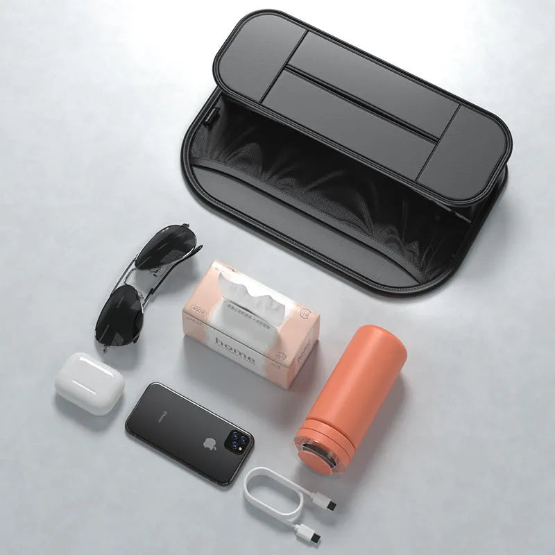 Black leather car seat rear storage bag showing its box shape and size against a vehicle seat.