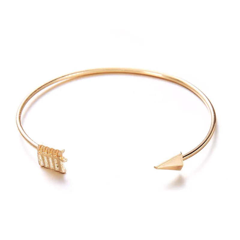 Gold vintage cuff bracelet for women with an arrow and knotted design detail.