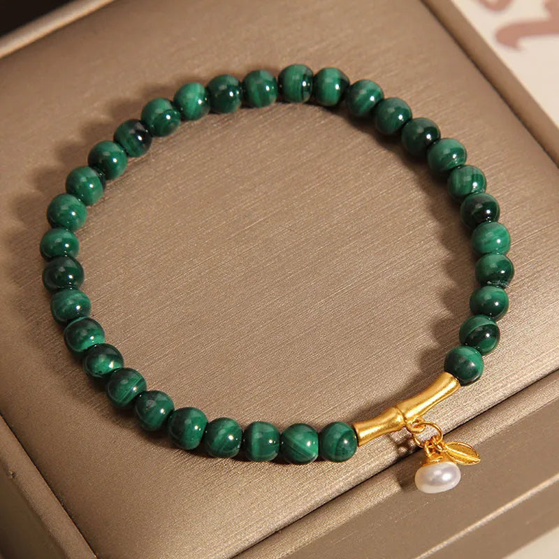 Women's white crystal lucky bamboo bracelet on display