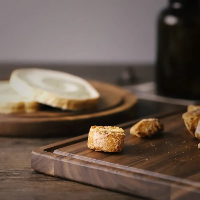 Black walnut wood cutting board with juice groove, dual-sided design, available in round and rectangular sizes for kitchen use