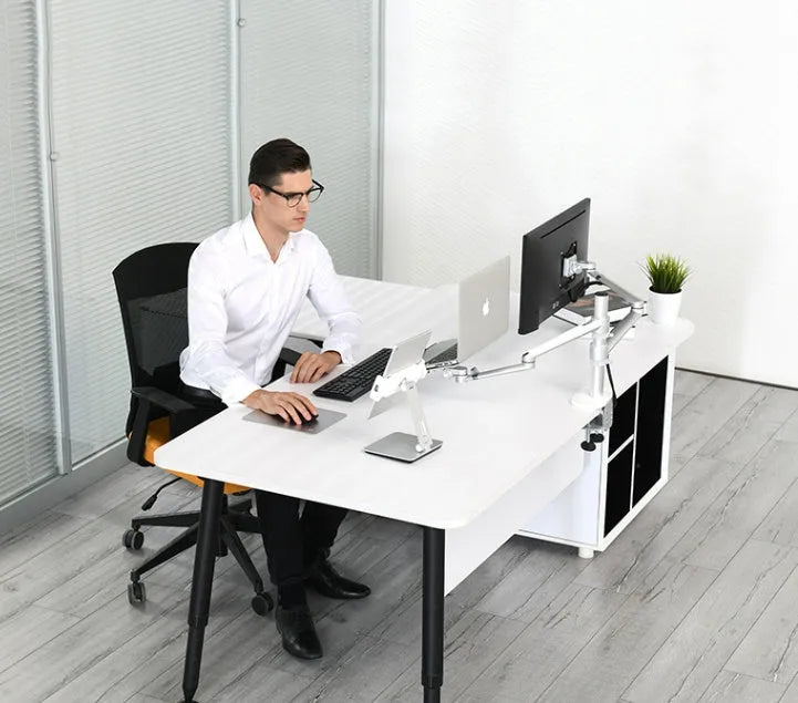 Folding aluminium and black plastic phone tablet stand on a desk, showing 360 degree rotation base.