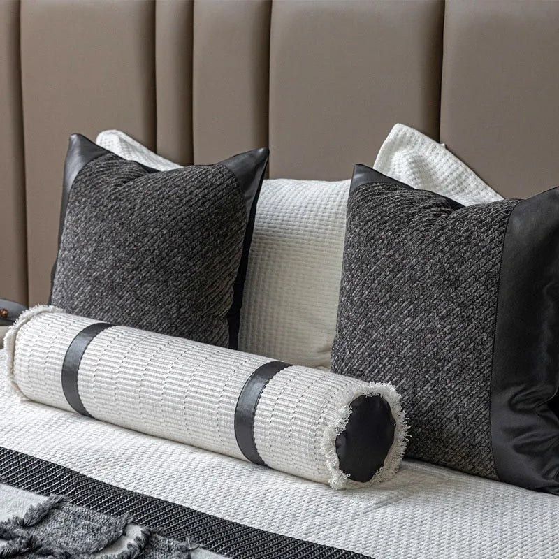 Modern minimalist grey and white plaid bed runner blanket set with matching pillow on a bed.
