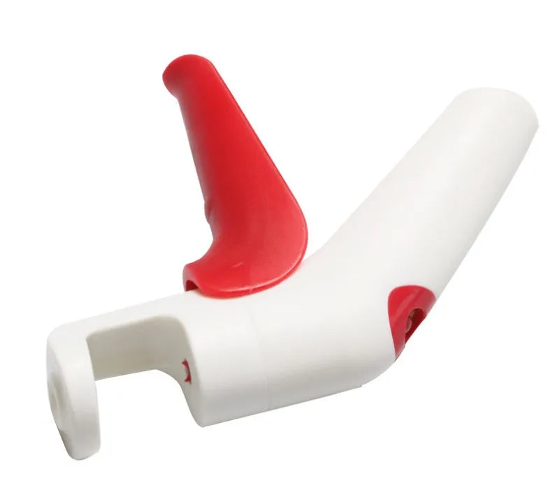 Cherry kernel remover, a handheld plastic kitchen gadget for pitting cherries, on a light background