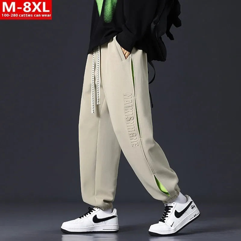 Men's loose-fit cotton trousers with printed stitching detail and ankle banding in grey green colour