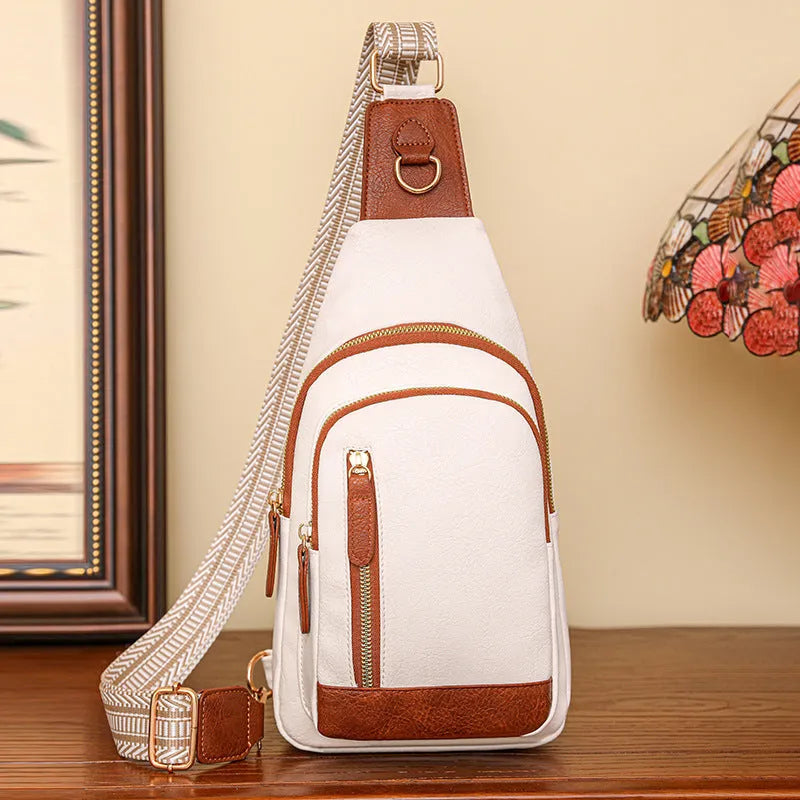 Soft PU women's crossbody bag in brown colour with open outer pocket and adjustable strap