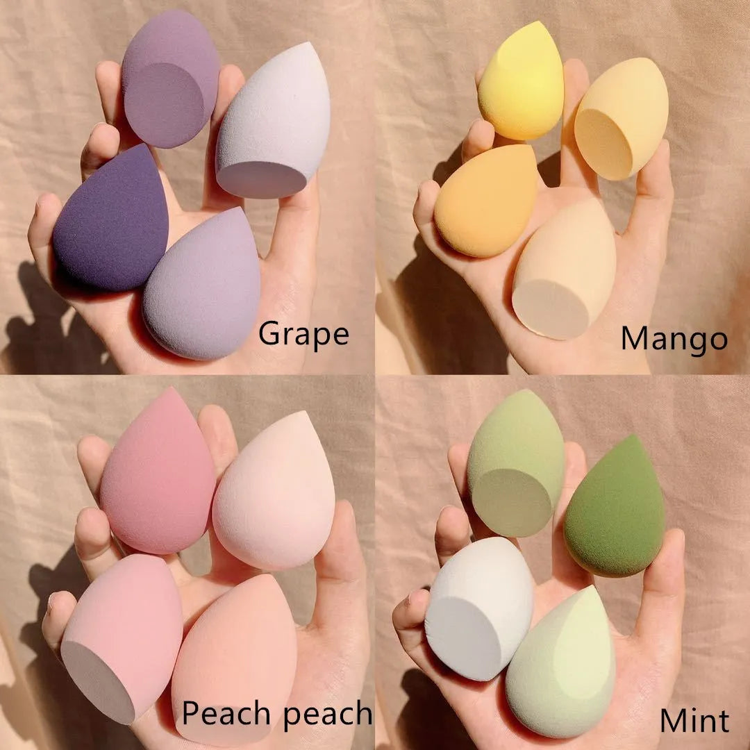 Set of four coloured makeup sponge eggs in grape, mango, mint, and peach peach, each measuring 6cm.