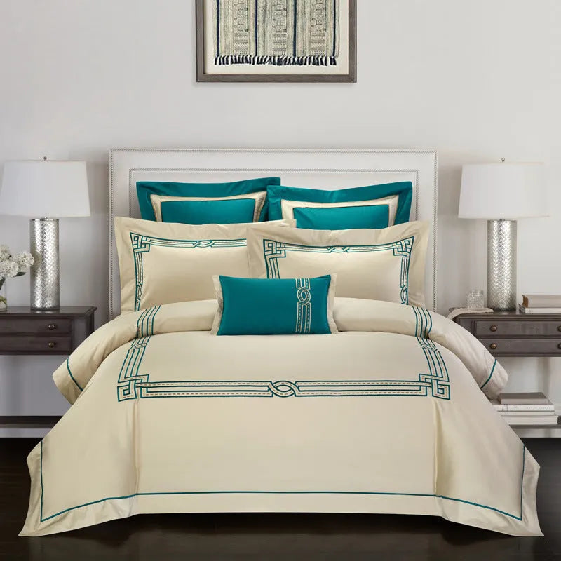Four-piece cotton embroidery bedding set in Charcoal colour on a bed with neutral decor