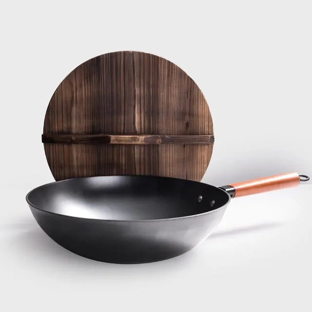Traditional handmade iron wok pan with wooden handle and black finish