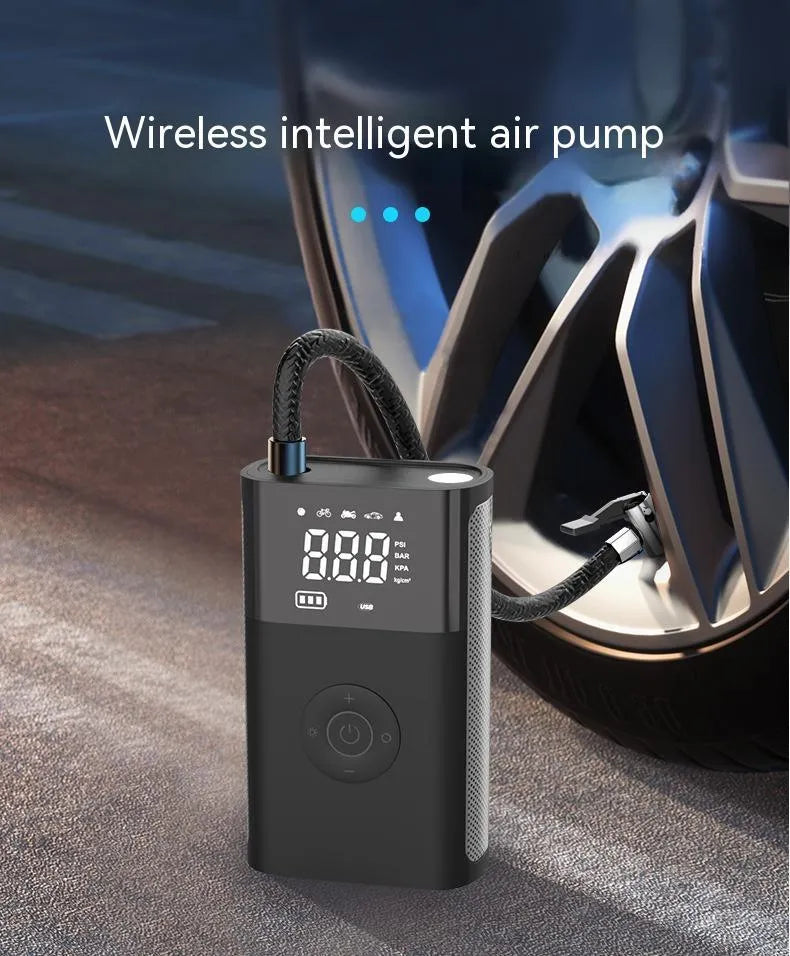 Handheld wireless digital display car tyre air pump with LED light and attachments on a grey background.
