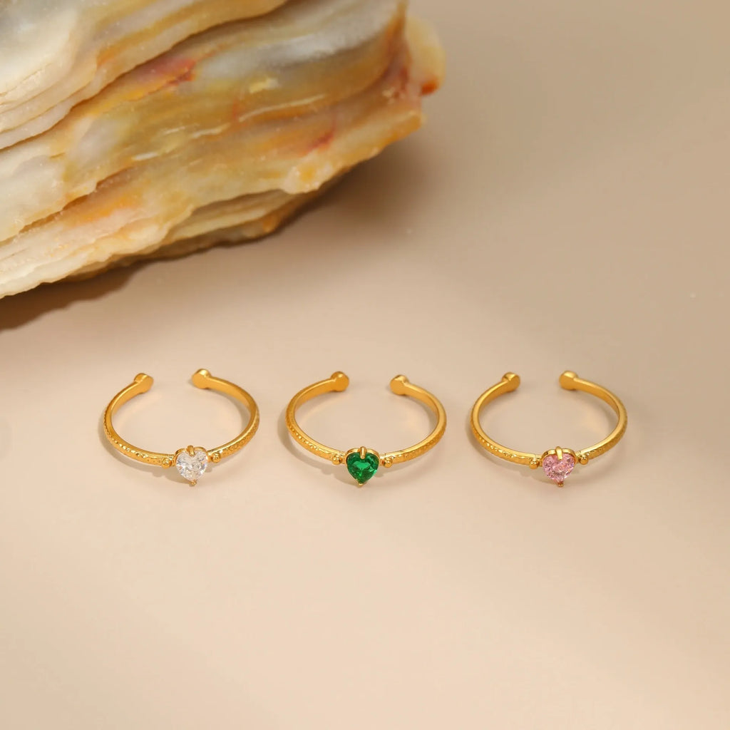Open-ended heart-shaped ring with geometric design and zircon stones in stainless steel