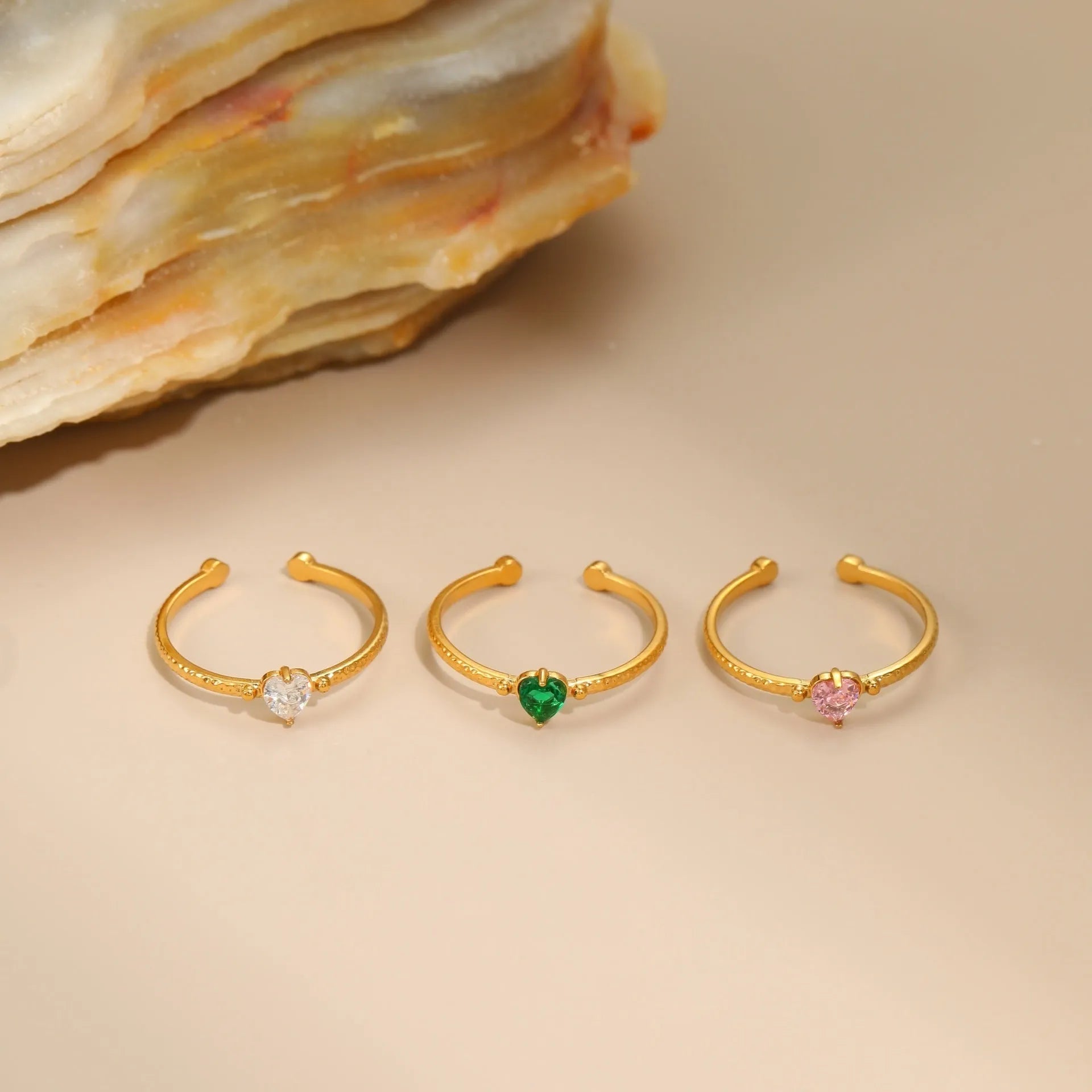 Open-ended heart-shaped ring with geometric design and zircon stones in stainless steel
