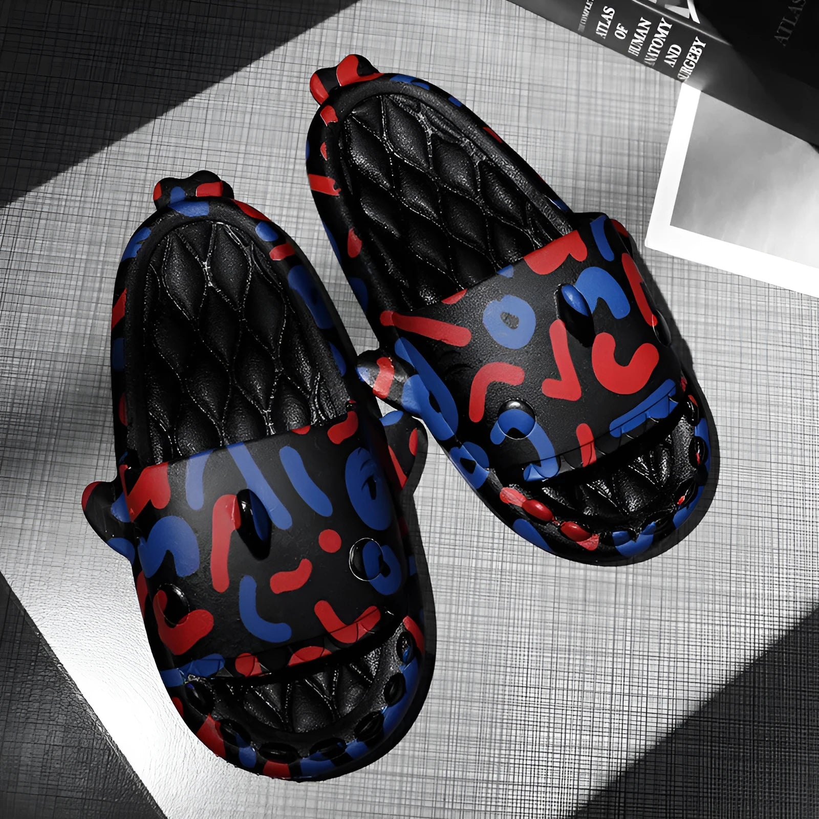 Shark couple design open-toe EVA home slippers on a plain background