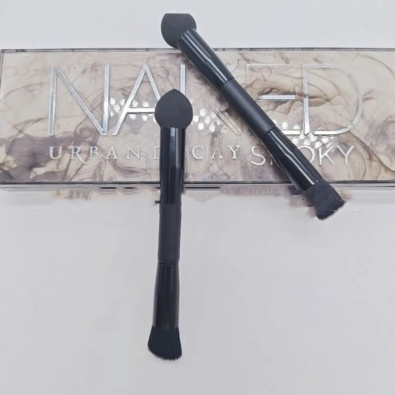 Black sponge stick concealer brush with wooden handle on white background
