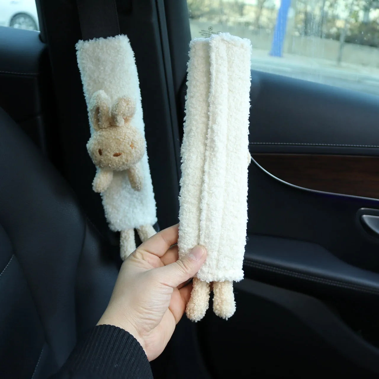 Soft plush car seatbelt shoulder protector with cartoon bear and rabbit designs made from lamb wool.