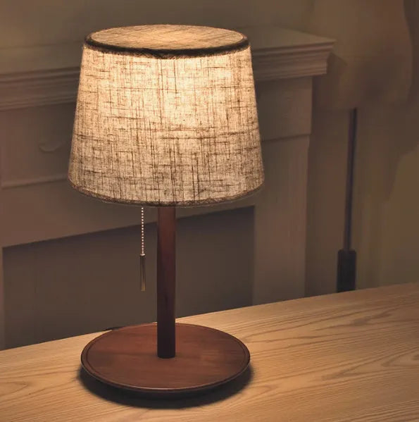 Walnut solid wood bedside lamp with cloth lampshade on wooden table