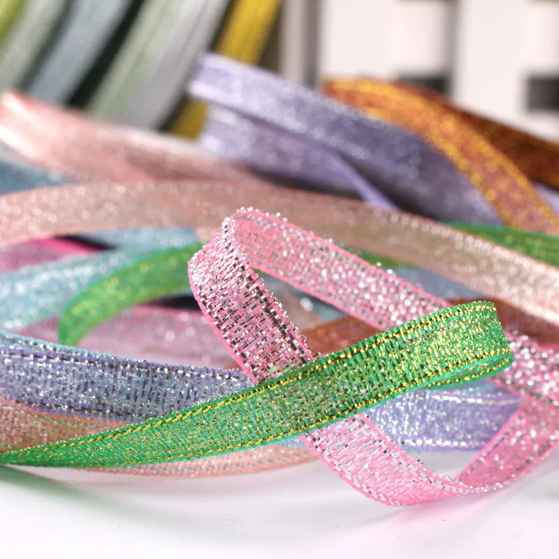 Roll of 0.6cm wide coloured polyester gift ribbon showing multiple colour options including metallic and fluorescent.