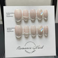 Women's handmade acrylic false nail set in blush armour colour, showing short ladder A design on a nail wheel.