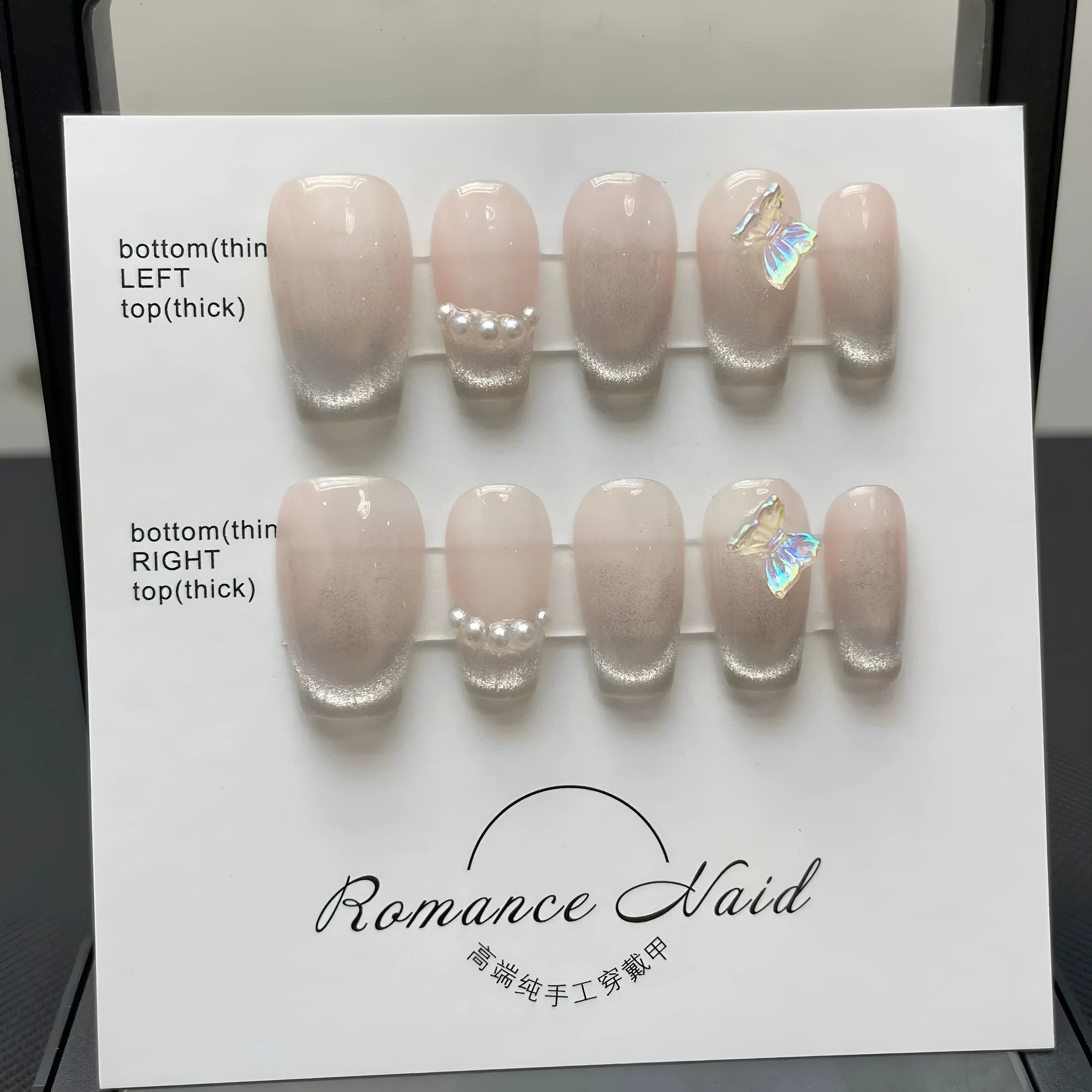 Women's handmade acrylic false nail set in blush armour colour, showing short ladder A design on a nail wheel.