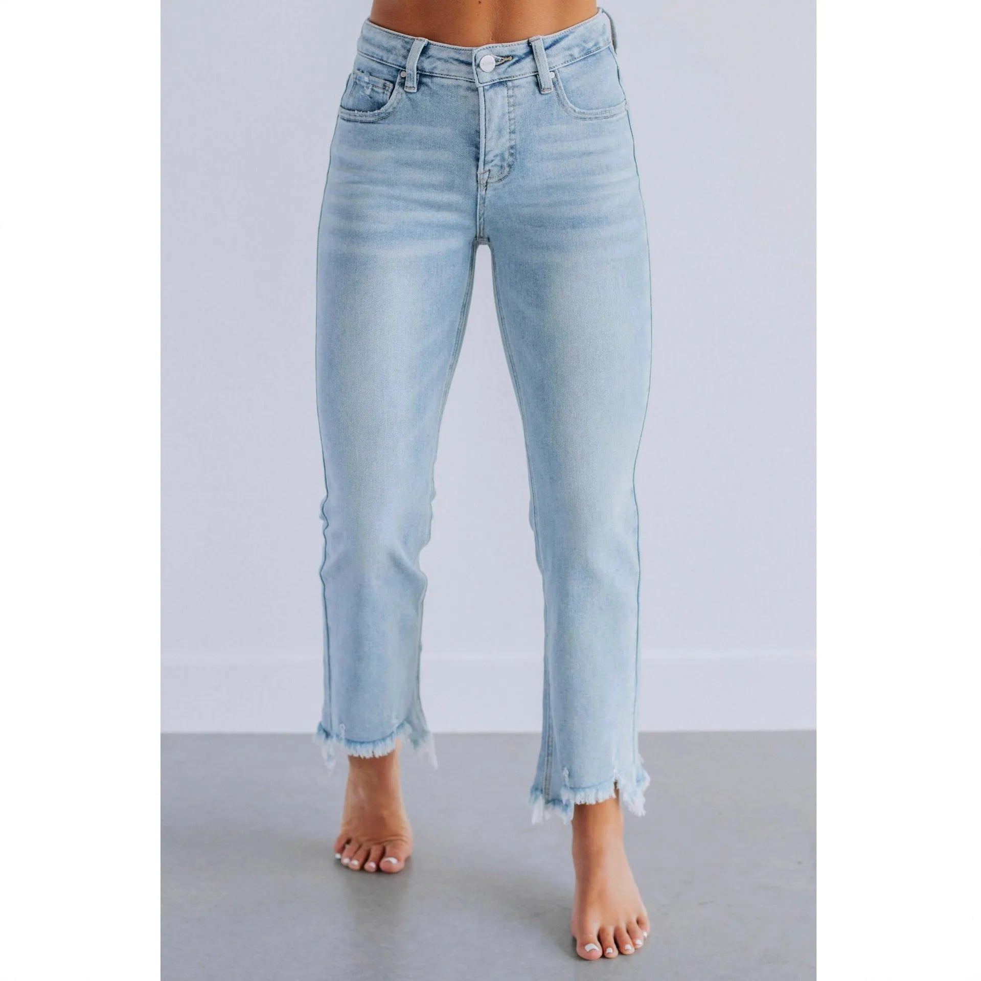 Women's solid colour denim jeans in dark blue and light blue, showing casual fit and hand-worn texture.