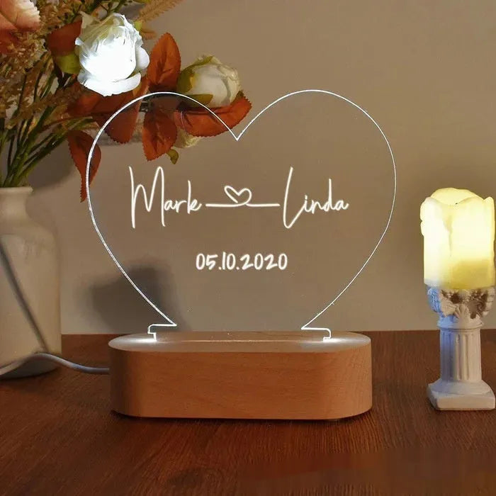 Custom acrylic LED night light with personalised names and dates illuminated