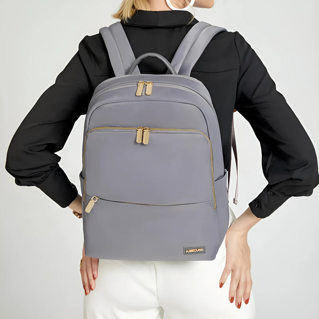 Large black and purplish grey Oxford cloth women's backpack showing anti-theft compartments and breathable back.