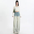 A pair of women's gradient blue straight-leg denim trousers with a wide leg opening, laid flat.