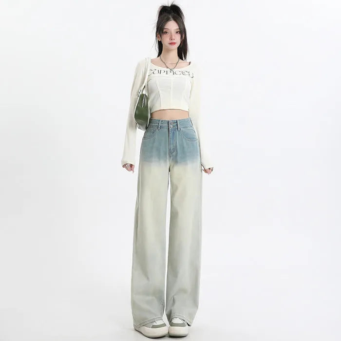 A pair of women's gradient blue straight-leg denim trousers with a wide leg opening, laid flat.