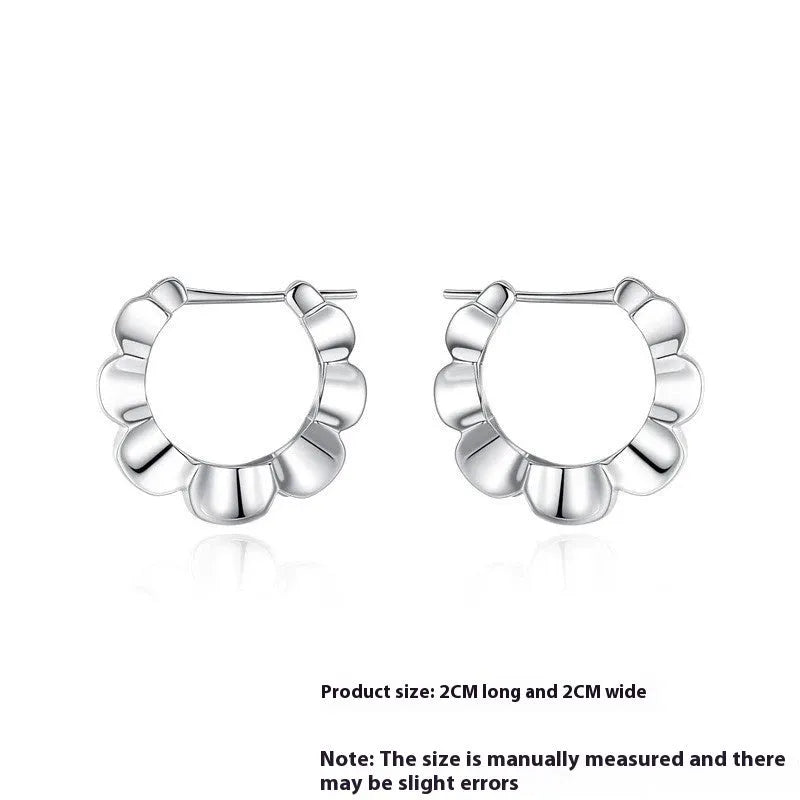 A pair of sterling silver geometric earrings with round details in a retro style.