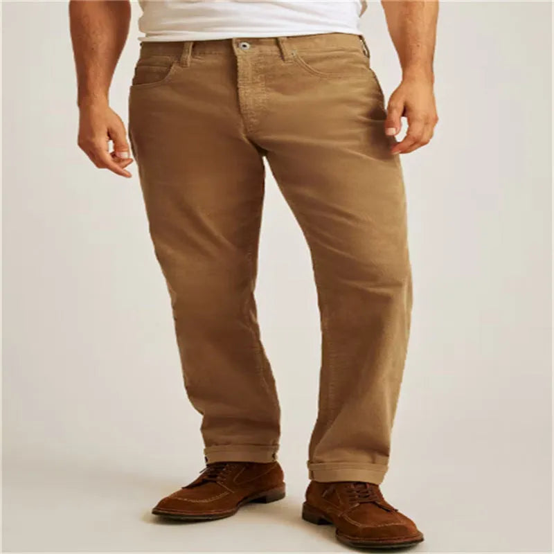 Straight leg corduroy trousers in army green colour, showing loose fit and zip fly detail.
