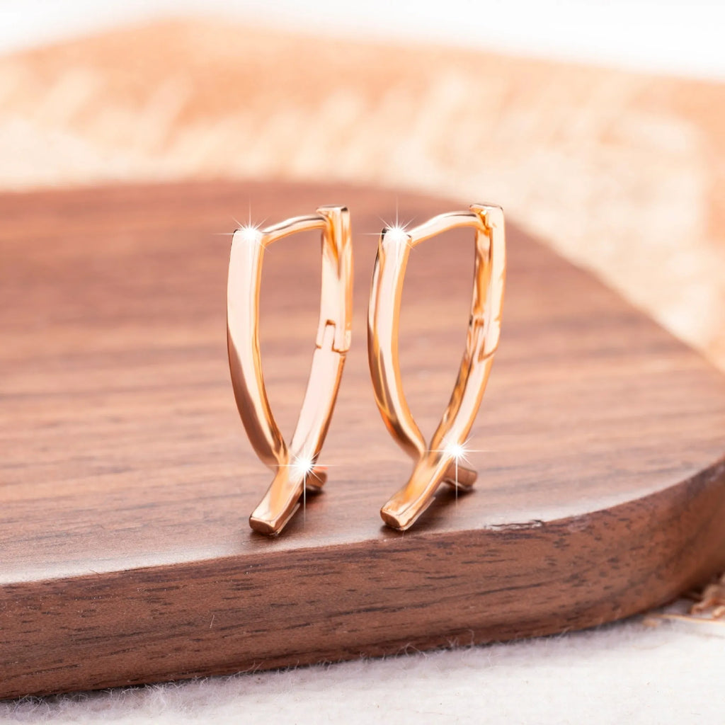 Rose gold plated copper cross shaped earrings with light luxury design