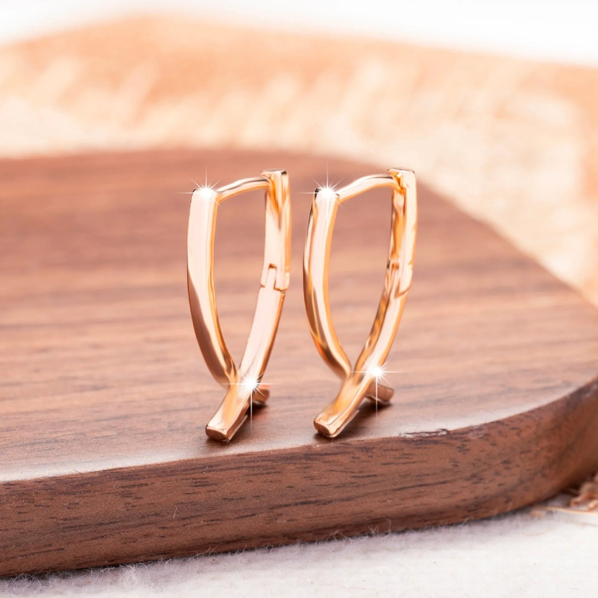 Rose gold plated copper cross shaped earrings with light luxury design