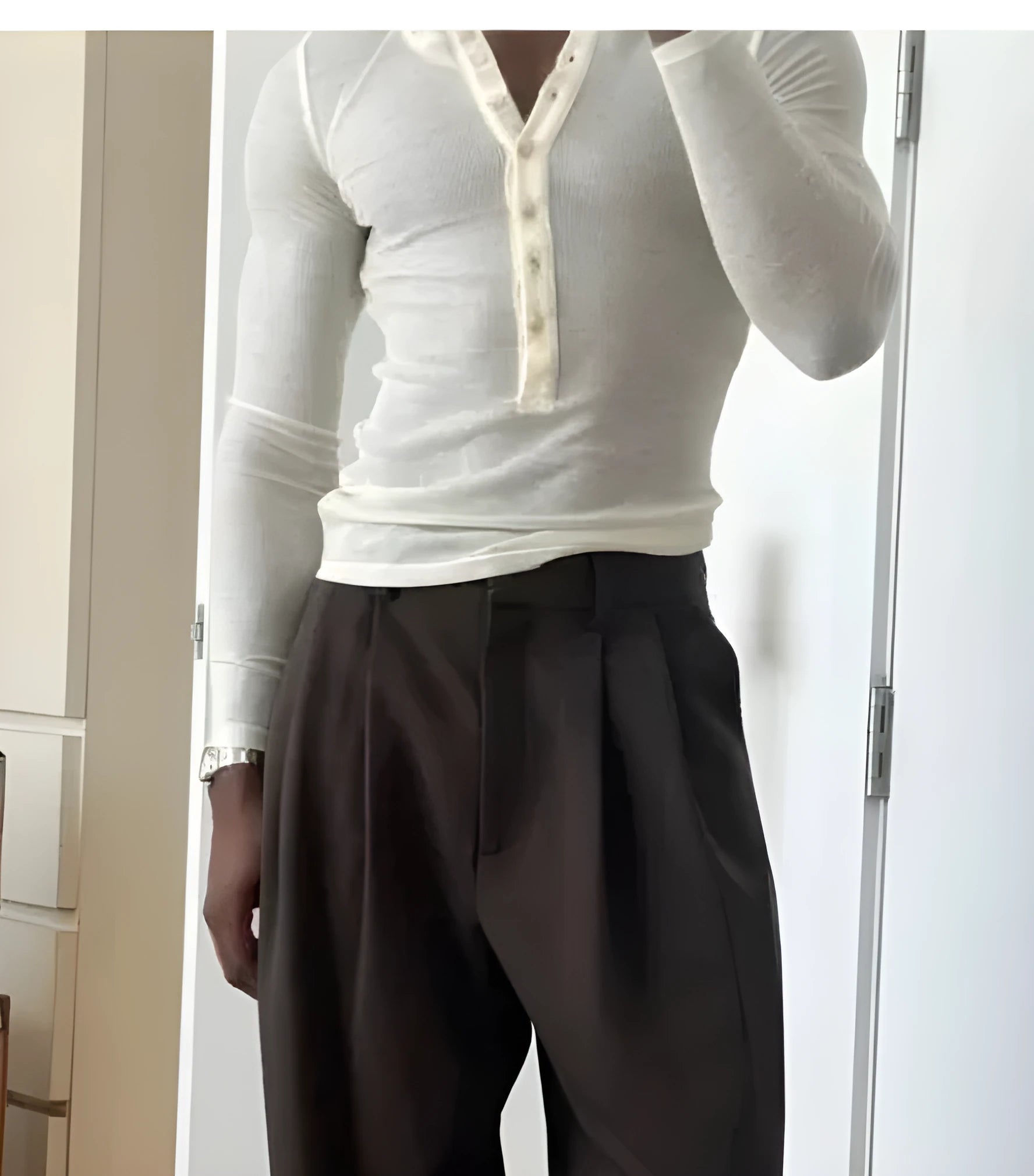 Men's cream-coloured ribbed long-sleeve Henley top with button placket on a mannequin.
