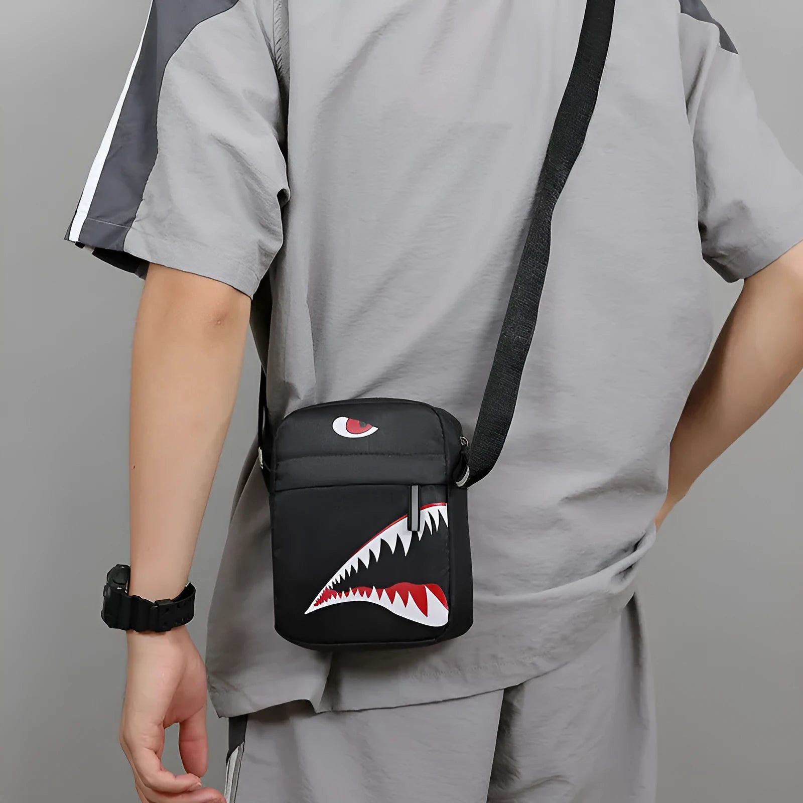 Men's black Oxford cloth crossbody bag with animal print pattern and adjustable shoulder strap