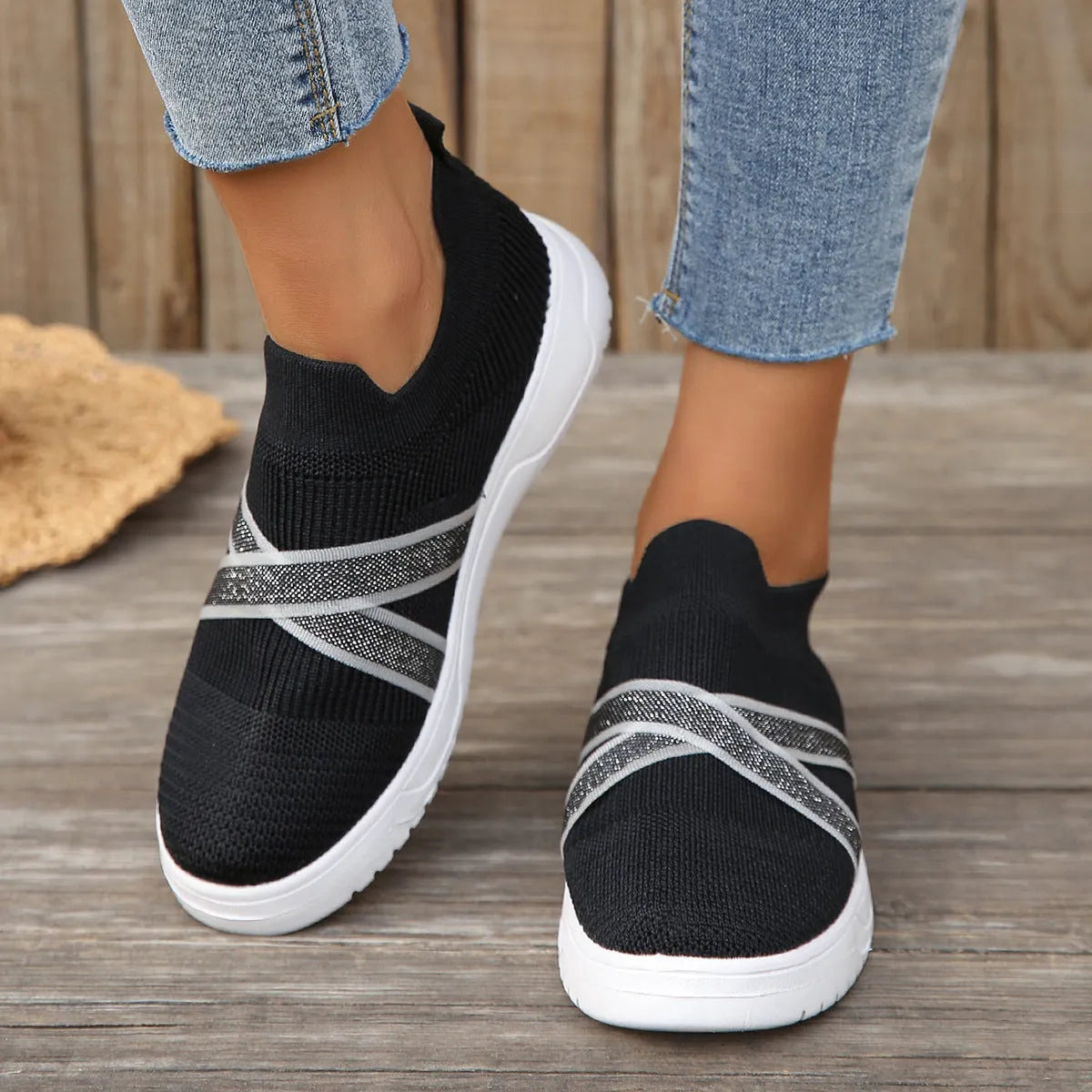 Women's black flat bottom flyknit mesh shoes with tassel detail, round toe, and rubber sole