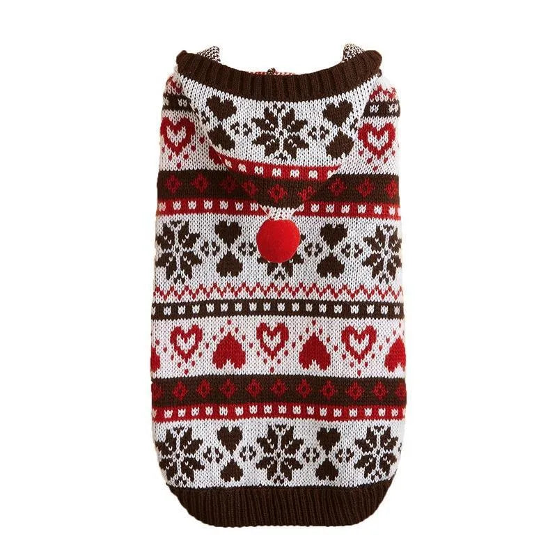 Pink knitted dog sweater with snowflake and striped camouflage patterns on a small Bichon dog