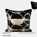 Black gold abstract patterned flannel decorative cushion on a sofa.