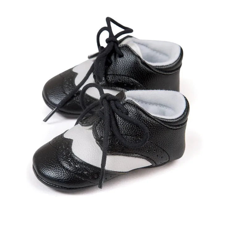 Vintage style baby shoes with soft soles in black synthetic leather