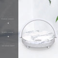 Marble pattern wireless charging night light with Bluetooth speaker and integrated phone holder.