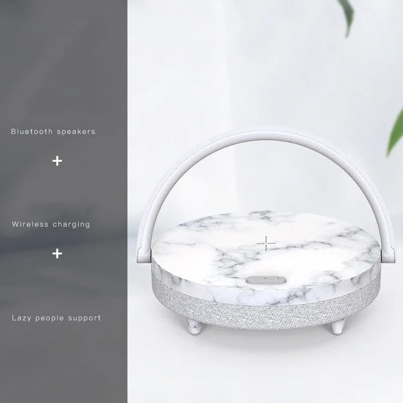 Marble pattern wireless charging night light with Bluetooth speaker and integrated phone holder.