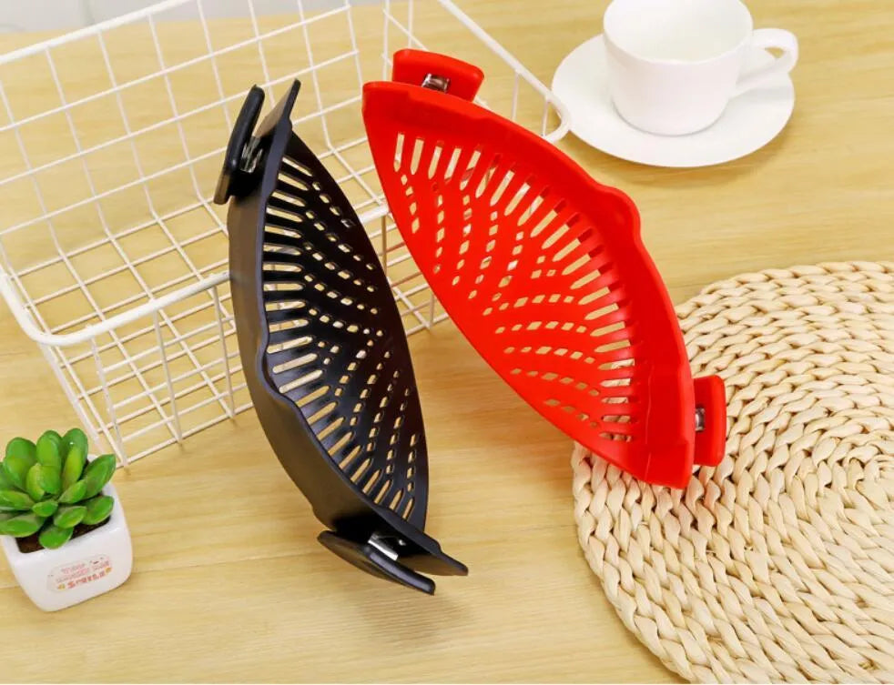 Silicone clip-on colander with stainless steel buckle attached to a pot, draining liquid, available in four colours.