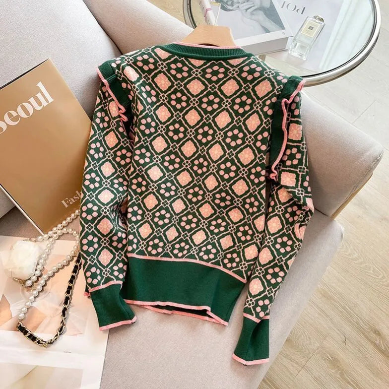 Women's green printed sweater with loose fit and regular sleeves shown on a model
